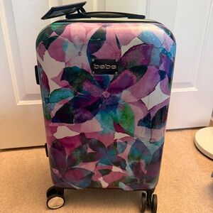 Bebe 21" hardside spinner suitcase with a watercolor floral pattern
